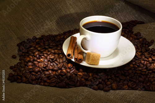 Photo: Coffee beans and white cup Coffee beans and white cup