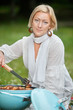 Photo: Female Preparing Food On Barbecue Female Preparing Food On Barbecue