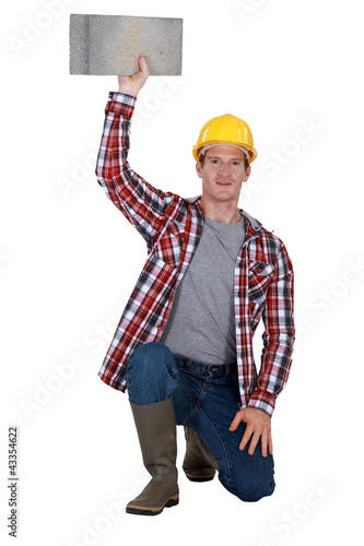Photo: portrait of bricklayer holding block of concrete portrait of bricklayer holding block of concrete