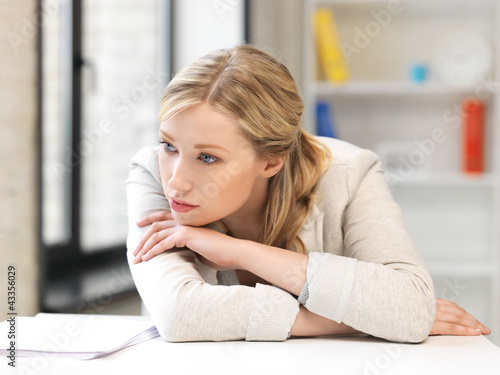 Photo: unhappy woman in office unhappy woman in office