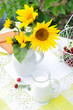 Still life with jug of milk and a bouquet  sunflowers