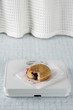 Photo: Jelly donut on a bathroom scale Jelly donut on a bathroom scale