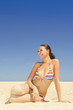 Caucasian woman sitting on beach