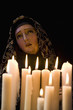 Candles and statue of Our Lady of Lourdes