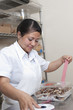 Hispanic baker working in commercial kitchen