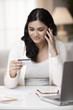Mixed race woman shopping online with credit card