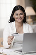 Mixed race woman shopping online with credit card