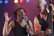 Black woman singing on stage with jazz band