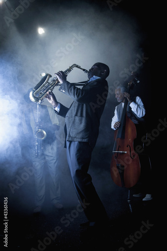 Photo: Musicians playing in jazz band on stage Musicians playing in jazz band on stage