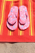 Foto: Sandals on beach towel Sandals on beach towel