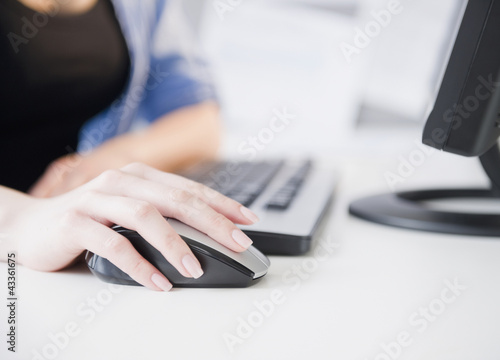 Photo: Close up of Korean woman using computer mouse Close up of Korean woman using computer mouse