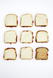Peanut butter and jelly sandwiches, one on whole wheat bread