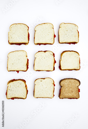 Photo: Peanut butter and jelly sandwiches, one on whole wheat bread Peanut butter and jelly sandwiches, one on whole wheat bread