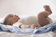 Mixed race baby boy laying on bed