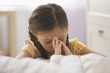 Caucasian girl kneeling by bed praying