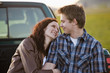 Caucasian couple hugging in back of truck