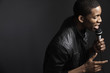 African American man singing into microphone