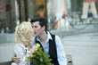 Caucasian couple kissing on bench