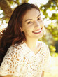 Happy beautiful woman laughing and smiling among the trees in nature