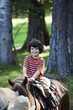 Caucasian boy riding a horse