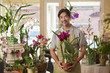 Japanese florist holding exotic flower