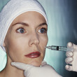Mixed race woman having facial injection