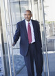 African American businessman opening glass door