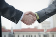 Businessmen shaking hands outdoors