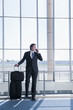 Caucasian businessman talking on cell phone in airport