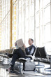 Caucasian businessman reading newspaper in airport