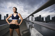 Photo: Hispanic woman in sportswear standing near urban waterfront Hispanic woman in sportswear standing near urban waterfront