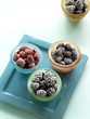 Cups of raspberries, marion berries and blackberry on serving tray