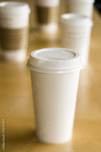 Photo: Row of disposable coffee cups Row of disposable coffee cups