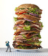 Toy man confronting world's largest sandwich