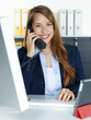 Foto: Secretary at work calling a customer for service Secretary at work calling a customer for service