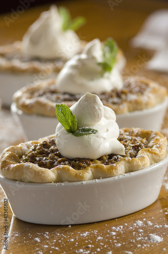 Photo: Row of single-serving pecan pies Row of single-serving pecan pies