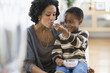 Photo: African American boy feeding mother ice cream African American boy feeding mother ice cream