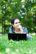 Beautiful young woman  using her laptop outdoors