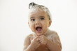 Mixed race baby girl taking a bath