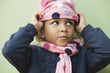 Mixed race girl putting on knit cap