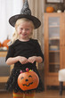 Caucasian girl in witch Halloween costume