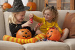 Caucasian girls in Halloween costumes eating candy