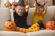Caucasian girls in Halloween costumes eating candy