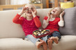 Caucasian girls eating Valentine's candy
