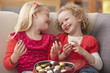 Caucasian girls eating Valentine's candy