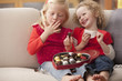 Caucasian girls eating Valentine's candy