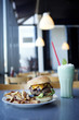 Cheeseburger, french fries and milkshake in diner