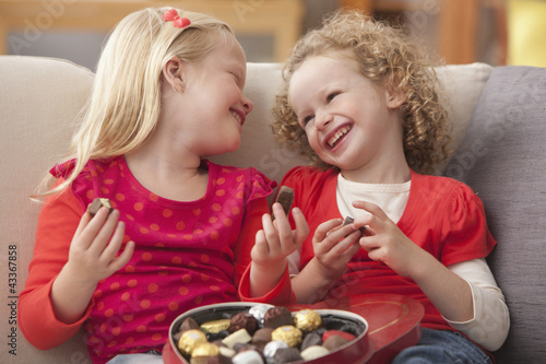 Photo: Caucasian girls eating Valentine's candy Caucasian girls eating Valentine's candy