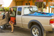 Hispanic woman getting out of truck