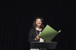 Smiling mixed race conductor holding folder